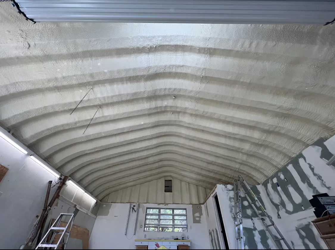 Spray polyurethane foam applied to the underside of a metal roof deck in Hurricane